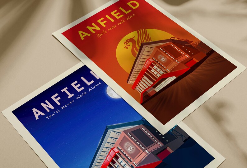 May include: Two art prints featuring Anfield stadium. One print has a red and orange background with the text "ANFIELD" and "You'll never walk alone". The other print has a blue background with the same text. Both prints have a white border.