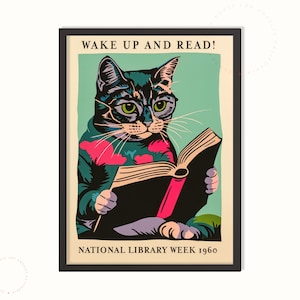 May include: A framed poster with a vintage illustration of a cat reading a book. The cat is black and green with green eyes and is wearing glasses. The poster has the text "WAKE UP AND READ!" and "NATIONAL LIBRARY WEEK 1960".