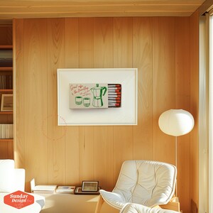May include: A framed print of a matchbox with a green illustration of a coffee pot and two cups. The text on the matchbox reads "Good coffee is the friendship that lasts forever".