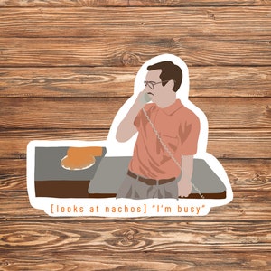 May include: A sticker featuring a cartoon illustration of a man on the phone, looking at a plate of nachos. The text reads "[looks at nachos] "I'm busy""