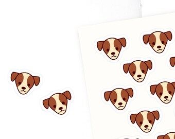 May include: A sheet of stickers featuring 20 brown and white dog faces with black eyes. The stickers are on a white background with the text "Olivia Planner Factory" in red at the bottom.