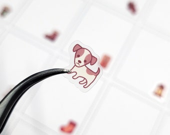 May include: A clear sticker featuring a cartoon illustration of a brown and white dog. The dog is looking to the left and has a pink nose.