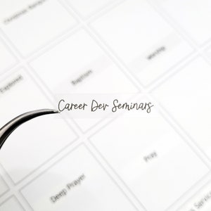 May include: A clear plastic label with the text "Career Dev Seminars" written in black cursive script.