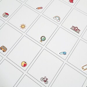 May include: White grid-lined paper with colorful school-themed stickers. Stickers include a pencil, rainbow, globe, schoolhouse, apple, bus, book, pen, bicycle, sun, and a tablet. The dotted lines create a grid pattern.