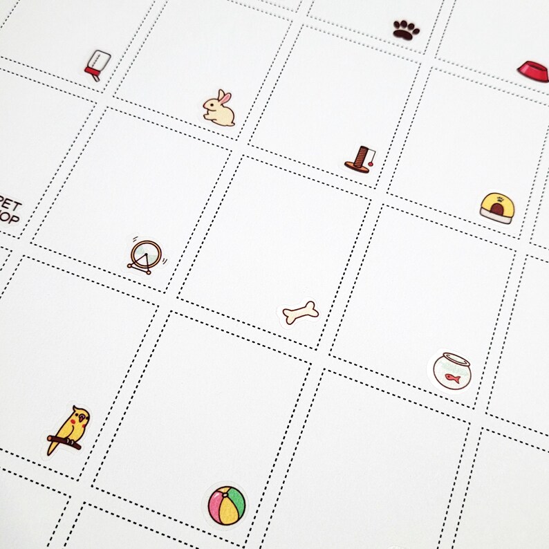 May include: A white sheet of paper with a grid of squares. Each square contains a different pet-related icon, such as a bone, a fishbowl, a paw print, a bird, a ball, a rabbit, a cat scratching post, a dog house, a clock, and a food bowl.
