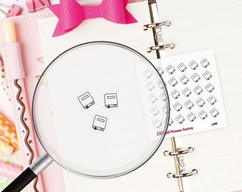 May include: A planner spread with a pink bow, binder clips, and a magnifying glass. The magnifying glass focuses on three small book stickers. A sheet of book stickers and the text "Olivia Planner Factory" are also visible.