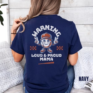 May include: A navy blue t-shirt with a baseball-themed graphic that says "Warning Loud & Proud Mama".