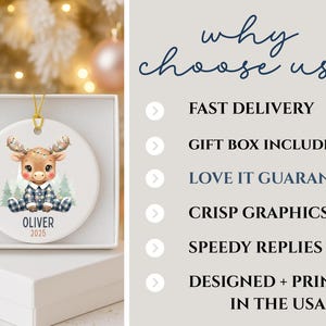 May include: A white ceramic Christmas ornament featuring a cartoon moose wearing a plaid outfit, sitting in front of pine trees. The ornament has a gold string for hanging and the name "Oliver" and the year "2025" are printed on it. The ornament is in a white gift box.