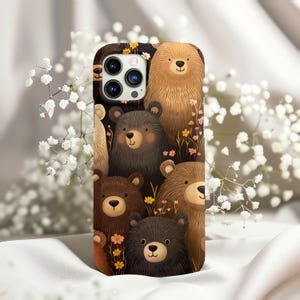 May include: A phone case with a brown, black, and white design featuring cartoon bears. The case has a camera cutout and a brown background.