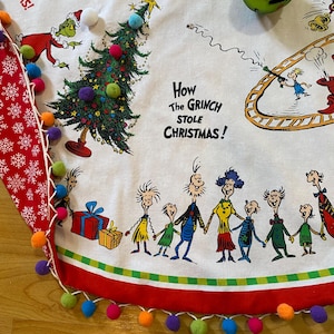 Falda para árbol de Navidad del Grinch: Falda reversible de 101 cm con ribete de pompones. Falda para árbol con diseño de Grinch y personajes tomados de la mano del Dr. Seuss.
