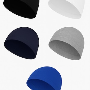 May include: Five solid-colored skull caps in black, white, navy blue, gray, and royal blue. The caps are made of a smooth, stretchy material and have a rounded shape, suitable for various activities. The caps are displayed against a white background.