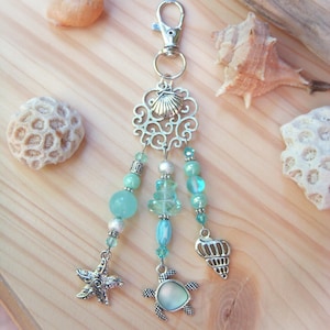 Turquoise blue and silver bag charm or key ring in glass and porcelain pearl with shell, turtle and starfish charm.
