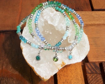 Set of 3 luminous bracelets in glass beads with multicolored blue/ green facets. matching glass charms. gift woman