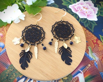 "Nocha" drop earrings with a black floral print and leaf, feather and flower pendants. Oriental style earrings.