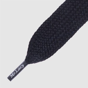 May include: Black shoelaces with a textured woven design. The shoelaces have the text "Mr. Lacy" printed on them.