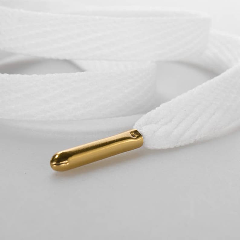 white flat laces with gold tips