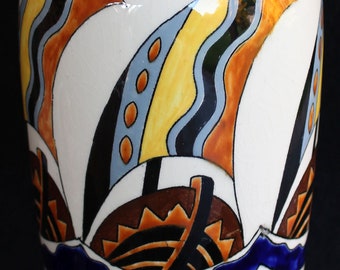 May include: A white ceramic vase with a geometric design of stylized ships and waves in shades of blue, green, yellow, orange, and brown.