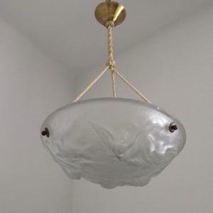 May include: A frosted glass pendant light fitting featuring a shallow bowl shape with embossed bird motifs. The bowl is suspended by three twisted beige ropes connected to a central brass-coloured ceiling canopy and hardware accents.