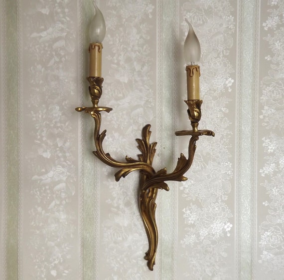 A Pair of Cast Brass Sconces in the Form of an Arrow with Face A Pair of Cast Brass Sconces in the Form of an Arrow with Face