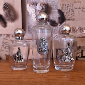 Set med 3 blandade franska vintage Lourdes souvenirglas vigvattenflaskor. Religiösa samlarflaskor. Vigvattenflaska med lock.