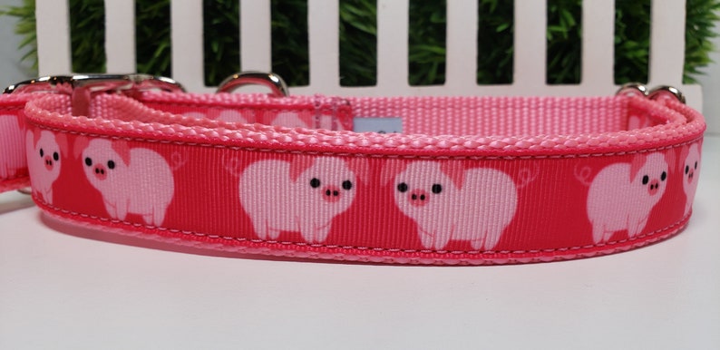 This adorable Pig Dog Collar, is a 1 inch wide Collar made with Grosgrain Ribbon that has a deep pink background with adorable Pink Pigs! It is shown on Light Pink Webbing Black available too. Buckle style of your choice also.