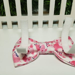 This adorable Pig Bow Tie has a White background with cute Pink Pigs. It is made with Cotton Fabric and Interfacing with either 2 hook and loop attachments.