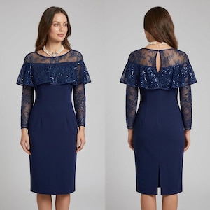 May include: A navy blue knee-length dress featuring a sheer lace overlay on the bodice and long sleeves. The dress includes a ruffled capelet detail adorned with sequins across the chest and shoulders, a round neckline, and a back keyhole opening.