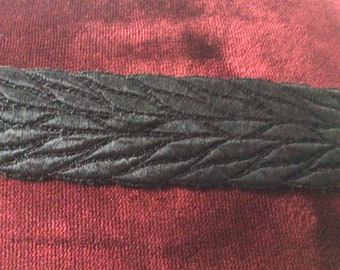 Black mercerized cotton trimmings measuring 5cm wide sold by the meter.