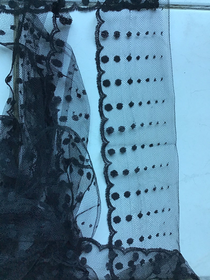 Very thin cotton black tulle measuring 8.5cm wide and sold by the meter