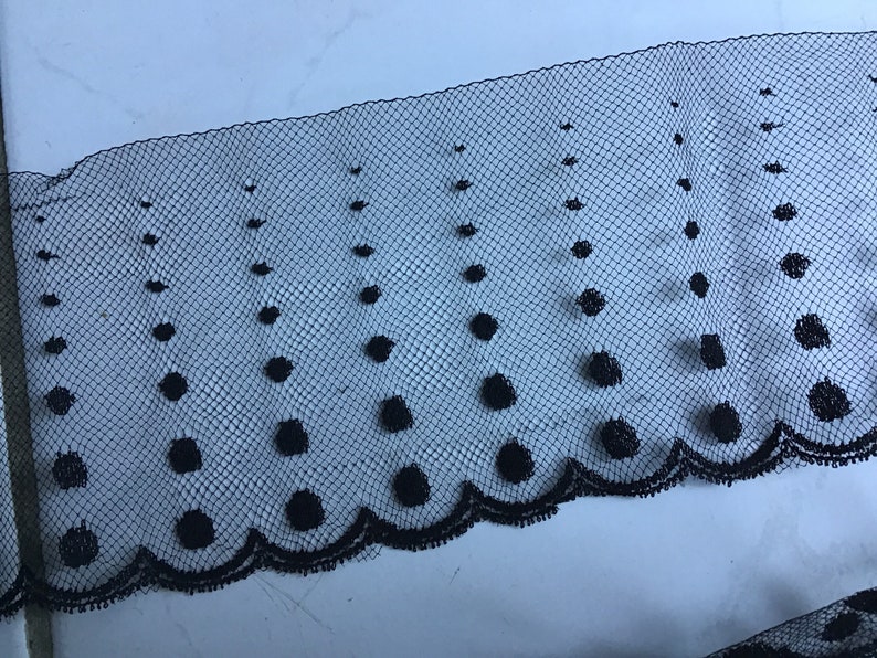 Very thin cotton black tulle measuring 8.5cm wide and sold by the meter
