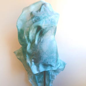 Luxury hand mint green black silk scarf made from 100% natural silk Habotai 5mm, lightweight artisan silk wrap with flowing watercolor design.
Batik shibori soft green beach silk sarong.