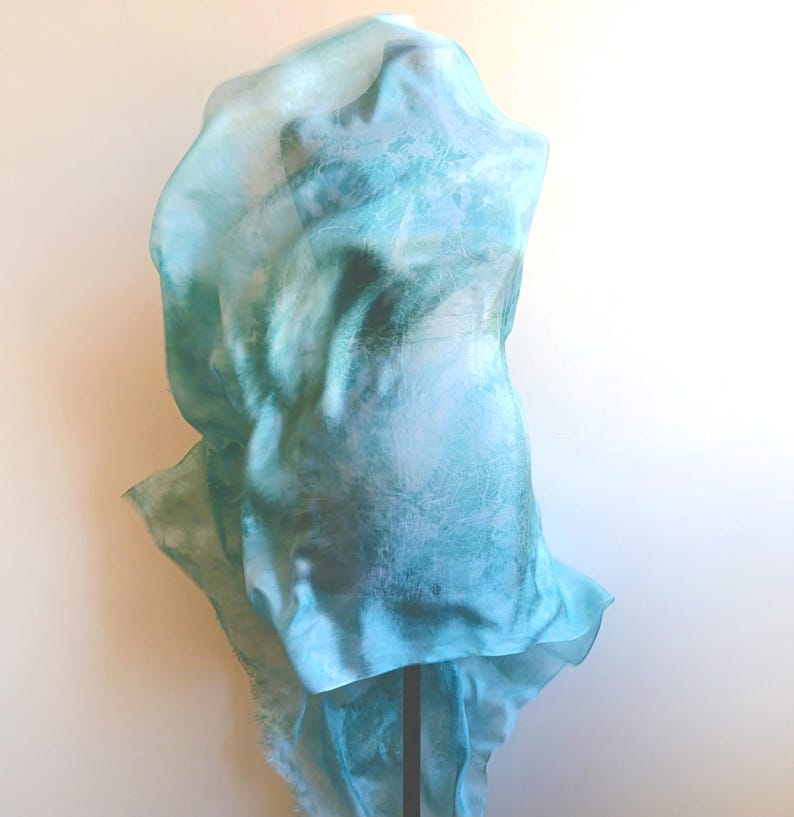 Luxury hand mint green black silk scarf made from 100% natural silk Habotai 5mm, lightweight artisan silk wrap with flowing watercolor design.
Batik shibori soft green beach silk sarong.