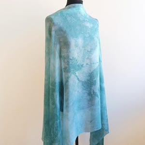 Luxury hand mint green black silk scarf made from 100% natural silk Habotai 5mm, lightweight artisan silk wrap with flowing watercolor design.
Batik shibori soft green beach silk sarong.