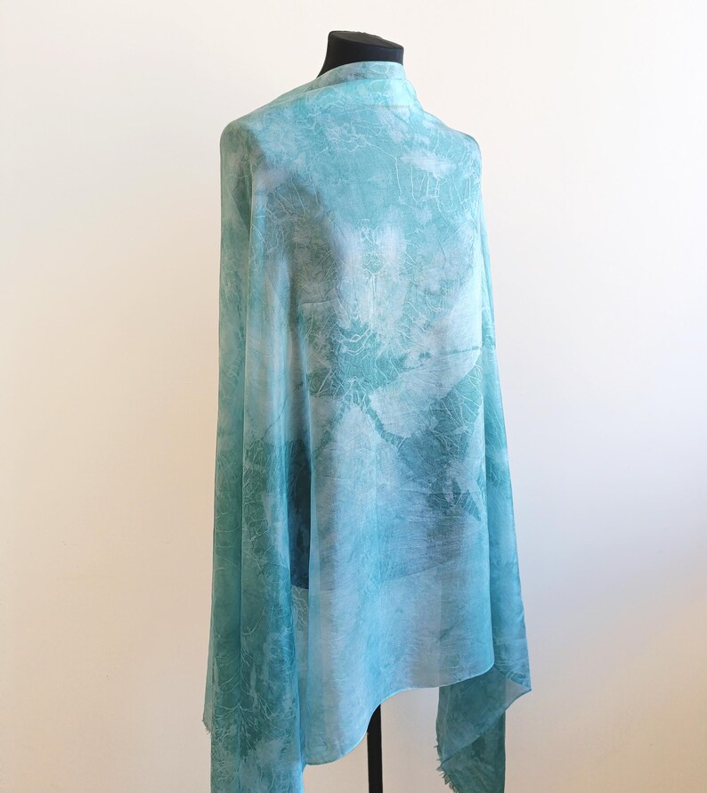 Luxury hand mint green black silk scarf made from 100% natural silk Habotai 5mm, lightweight artisan silk wrap with flowing watercolor design.
Batik shibori soft green beach silk sarong.