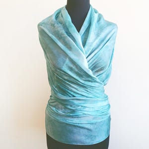 Luxury hand mint green black silk scarf made from 100% natural silk Habotai 5mm, lightweight artisan silk wrap with flowing watercolor design.
Batik shibori soft green beach silk sarong.