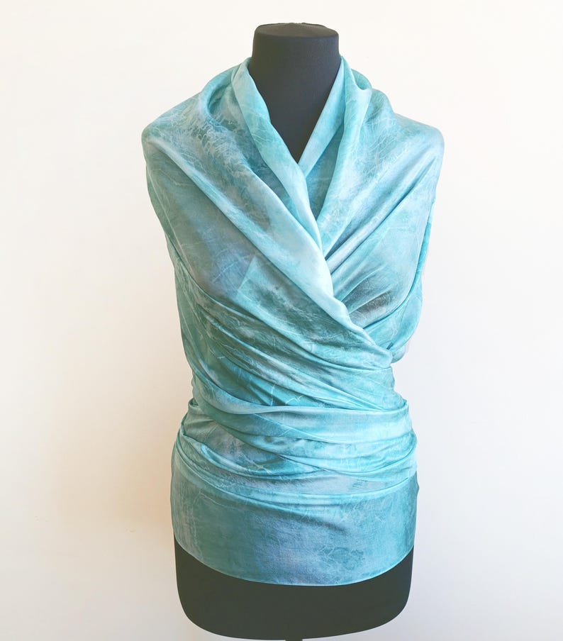 Luxury hand mint green black silk scarf made from 100% natural silk Habotai 5mm, lightweight artisan silk wrap with flowing watercolor design.
Batik shibori soft green beach silk sarong.