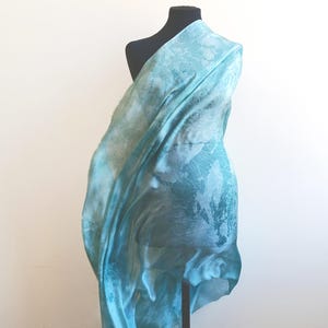 Luxury hand mint green black silk scarf made from 100% natural silk Habotai 5mm, lightweight artisan silk wrap with flowing watercolor design.
Batik shibori soft green beach silk sarong.