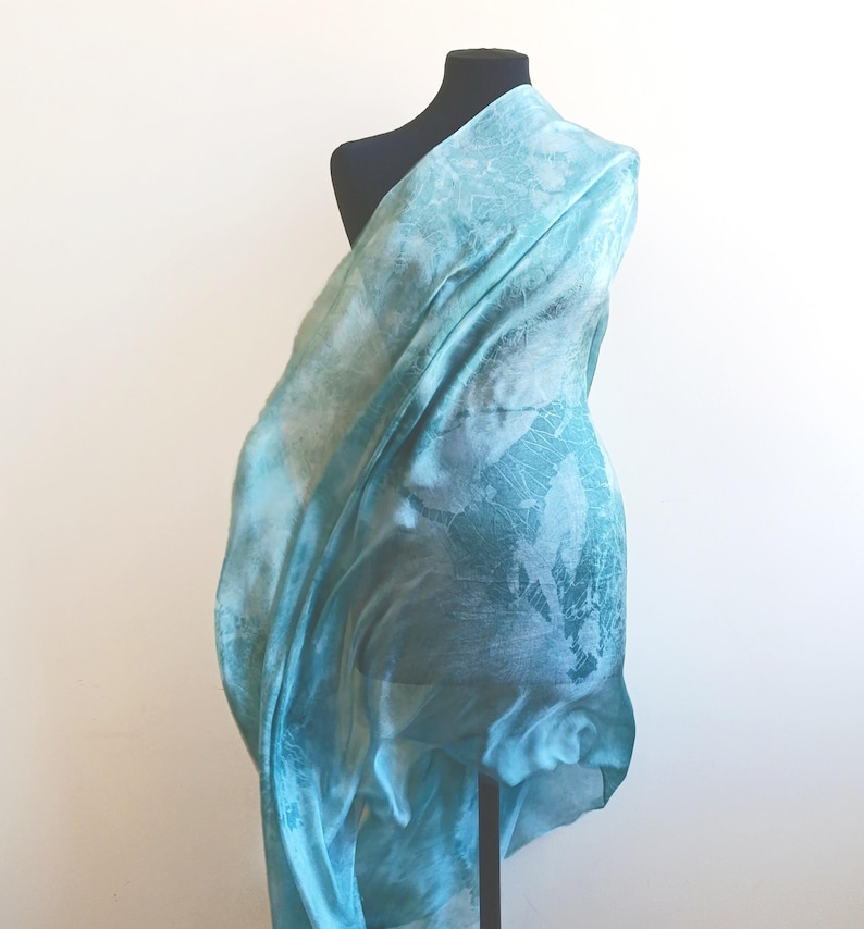 Luxury hand mint green black silk scarf made from 100% natural silk Habotai 5mm, lightweight artisan silk wrap with flowing watercolor design.
Batik shibori soft green beach silk sarong.