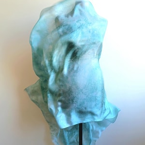 Luxury hand mint green black silk scarf made from 100% natural silk Habotai 5mm, lightweight artisan silk wrap with flowing watercolor design.
Batik shibori soft green beach silk sarong.