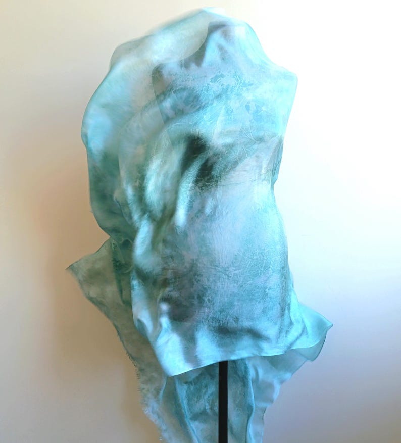 Luxury hand mint green black silk scarf made from 100% natural silk Habotai 5mm, lightweight artisan silk wrap with flowing watercolor design.
Batik shibori soft green beach silk sarong.