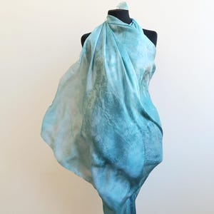 Luxury hand mint green black silk scarf made from 100% natural silk Habotai 5mm, lightweight artisan silk wrap with flowing watercolor design.
Batik shibori soft green beach silk sarong.