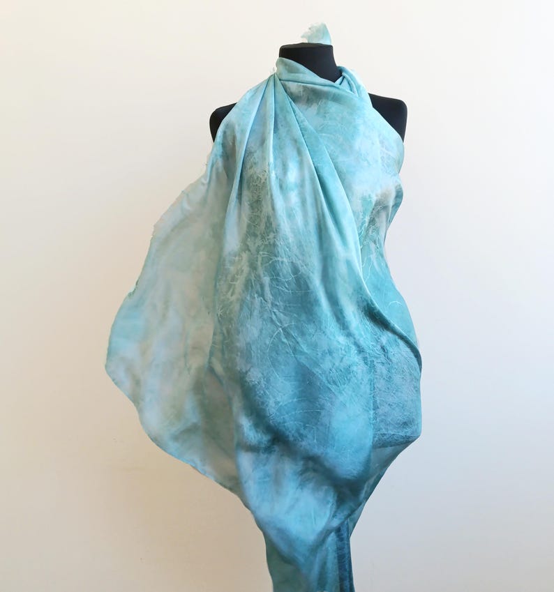 Luxury hand mint green black silk scarf made from 100% natural silk Habotai 5mm, lightweight artisan silk wrap with flowing watercolor design.
Batik shibori soft green beach silk sarong.