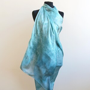 Luxury hand mint green black silk scarf made from 100% natural silk Habotai 5mm, lightweight artisan silk wrap with flowing watercolor design.
Batik shibori soft green beach silk sarong.