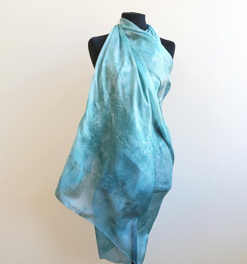 Luxury hand mint green black silk scarf made from 100% natural silk Habotai 5mm, lightweight artisan silk wrap with flowing watercolor design.
Batik shibori soft green beach silk sarong.