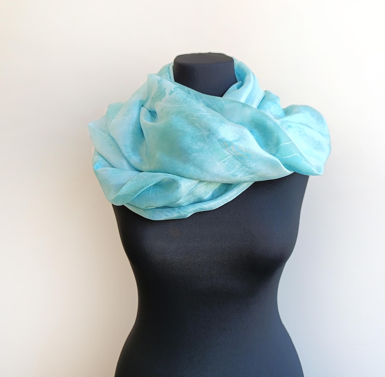 Luxury hand mint green black silk scarf made from 100% natural silk Habotai 5mm, lightweight artisan silk wrap with flowing watercolor design.
Batik shibori soft green beach silk sarong.