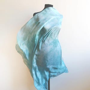 Luxury hand mint green black silk scarf made from 100% natural silk Habotai 5mm, lightweight artisan silk wrap with flowing watercolor design.
Batik shibori soft green beach silk sarong.