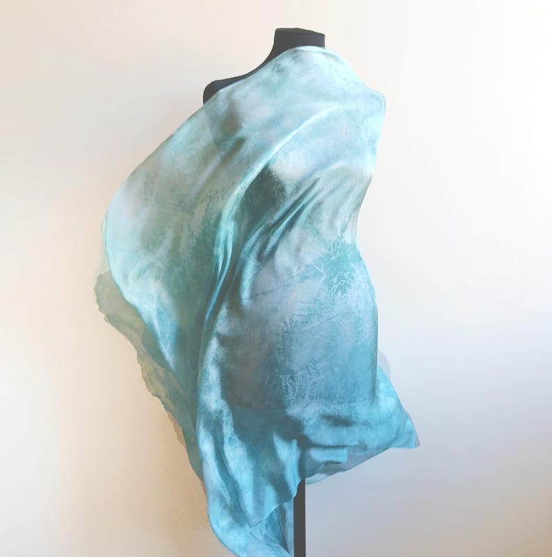 Luxury hand mint green black silk scarf made from 100% natural silk Habotai 5mm, lightweight artisan silk wrap with flowing watercolor design.
Batik shibori soft green beach silk sarong.