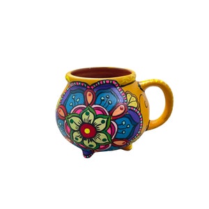 mandala mug made of clay hand painted by mexican indigenous in bright neon colors with drawings of mandala flowers.