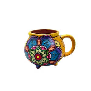 mandala mug made of clay hand painted by mexican indigenous in bright neon colors with drawings of mandala flowers.