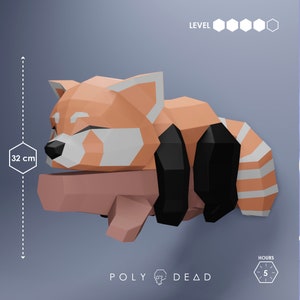 May include: A papercraft red panda sculpture, 32 cm in length, in a sleeping pose. The sculpture features orange, white, and black geometric shapes. The sculpture is resting on a light brown surface. The text "POLY DEAD" is at the bottom.